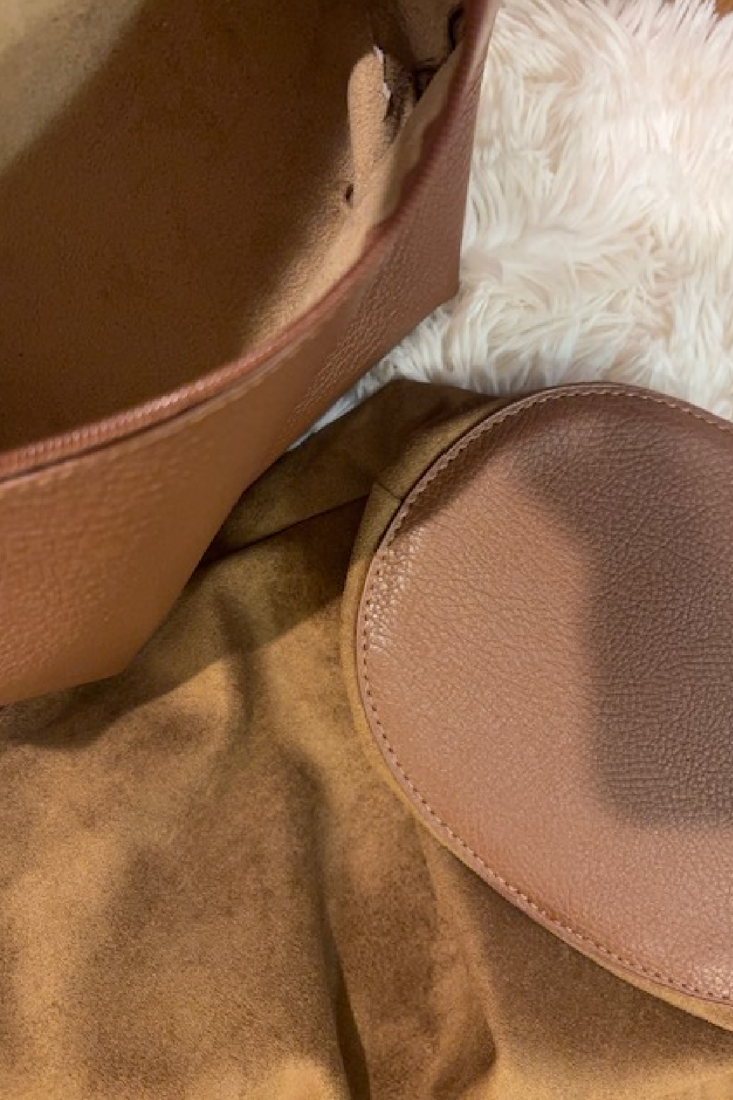 Suede slouchy shoulder bag interior view with tan leather pocket and contrast stitching