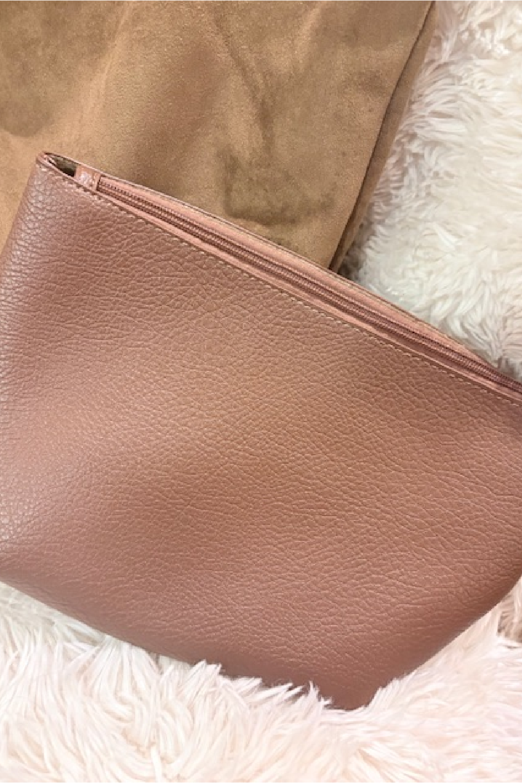 Suede slouchy shoulder bag exterior with taupe leather finish and slim zip closure