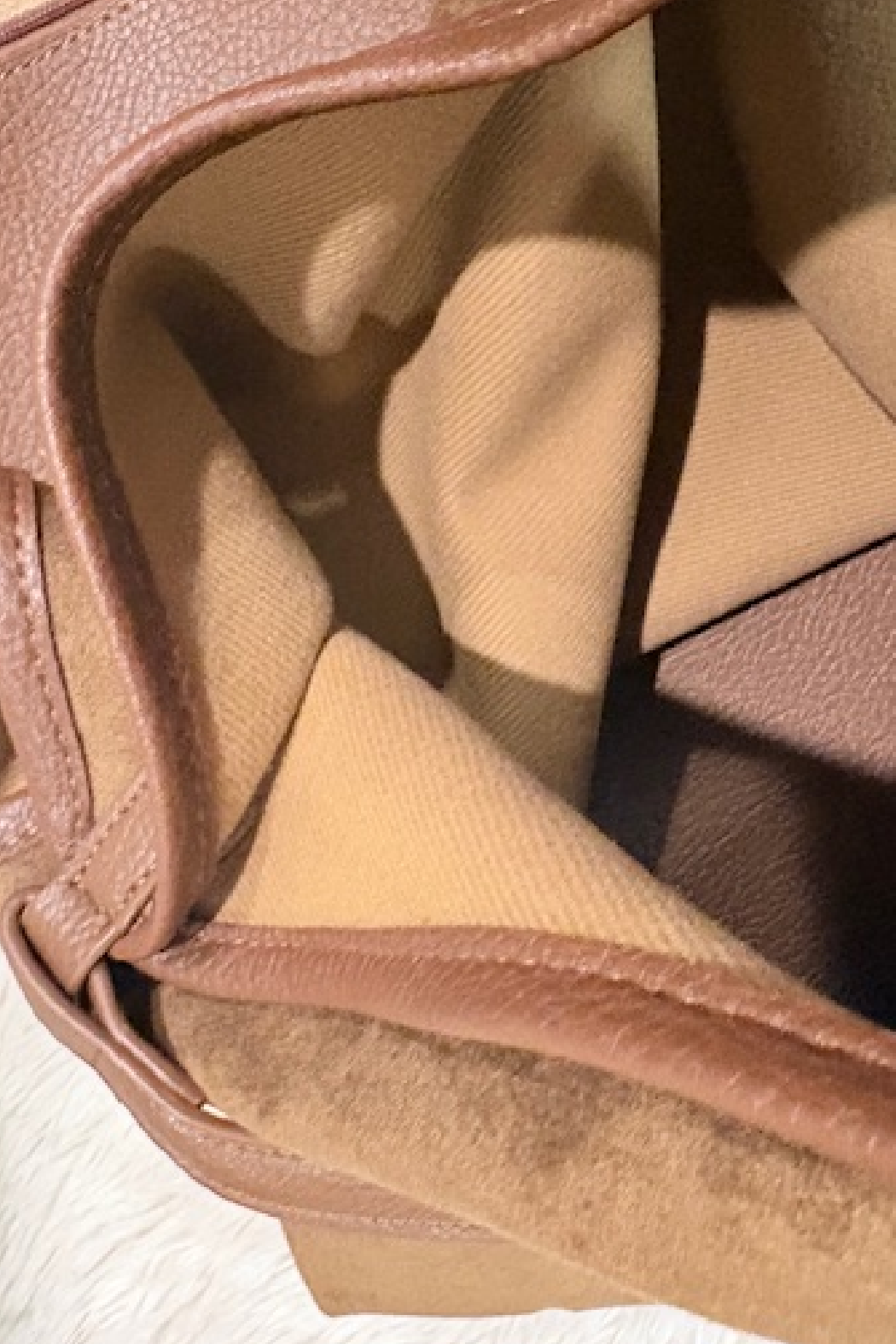 Suede slouchy shoulder bag interior with leather trim and top zipper opening