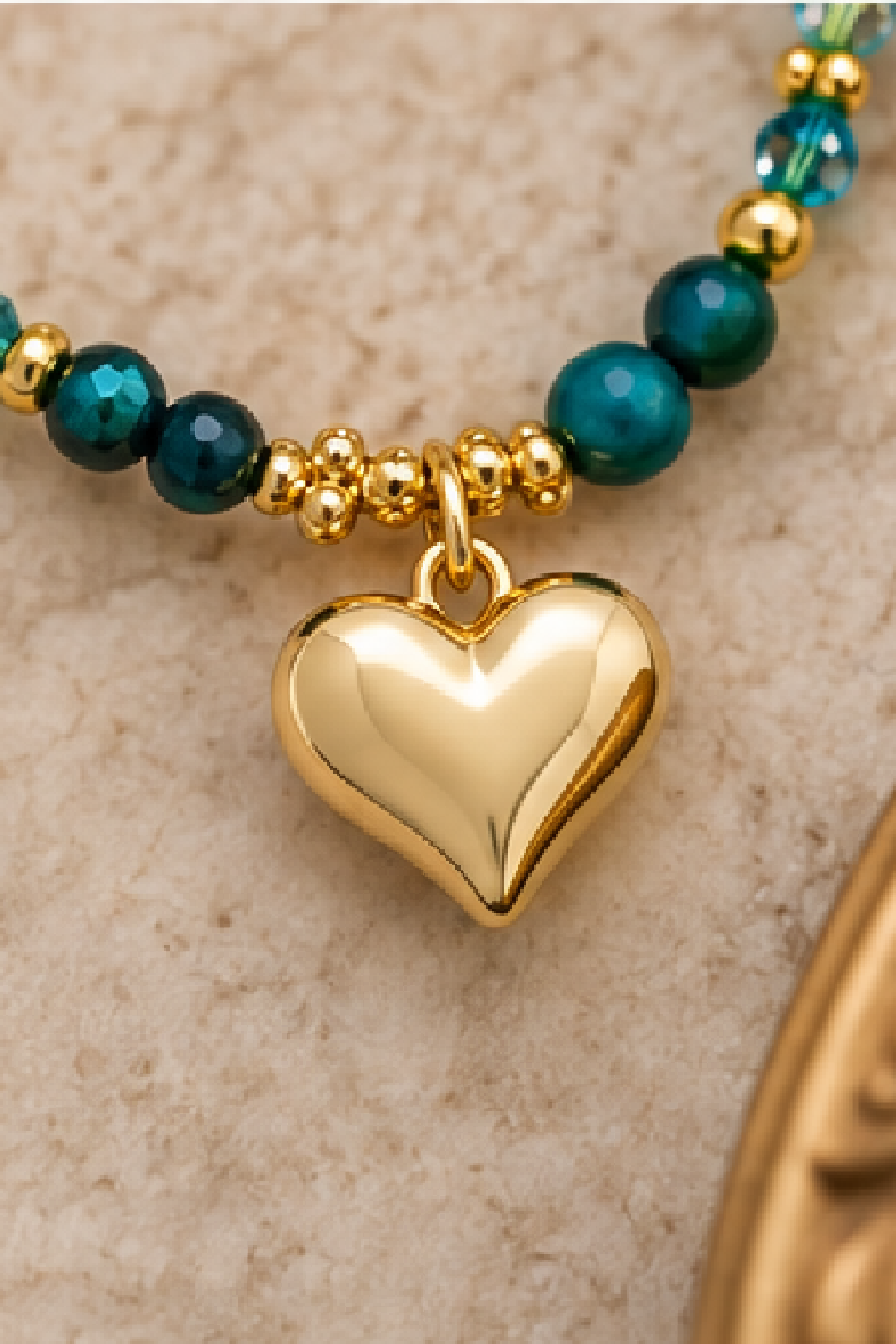 Gold heart pendant necklace with dark teal aventurine beads and gold clasp links