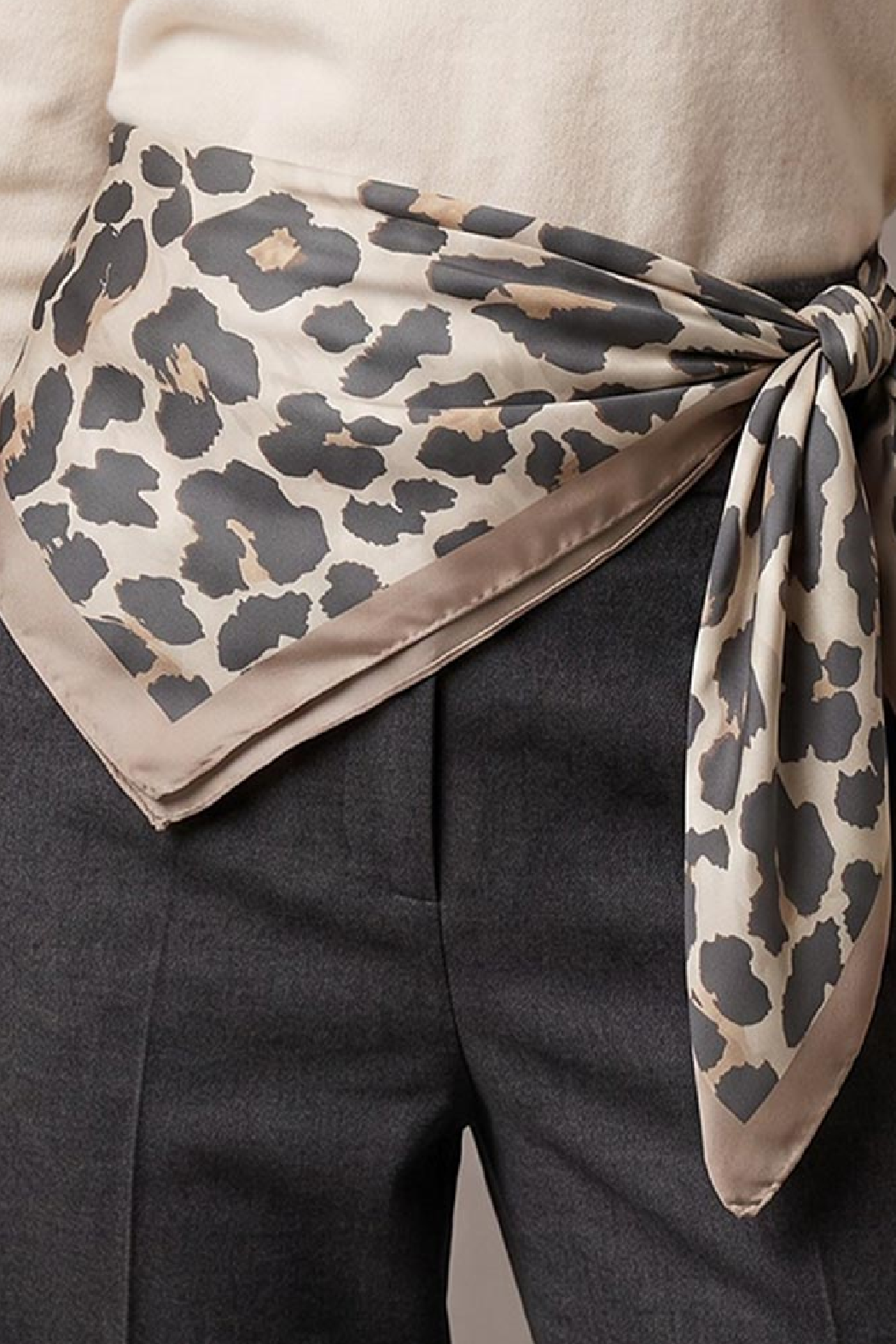Leopard-print scarf with charcoal spots, taupe border, tied at the waist