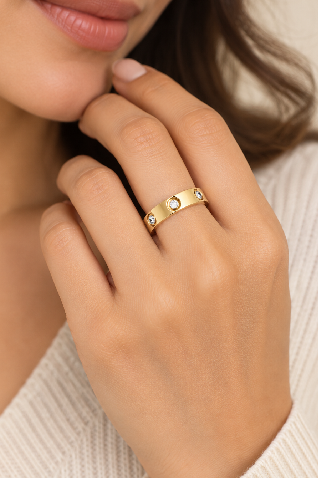 Gold crystal ring with small round clear stones across the band