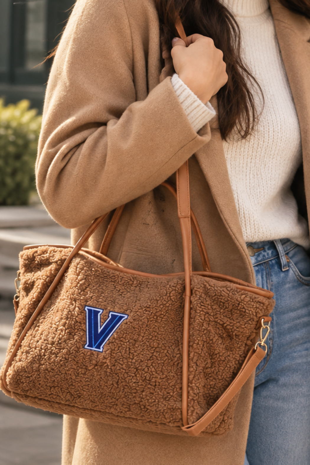 Sherpa tote shoulder bag in brown with blue V logo and leather-look handles